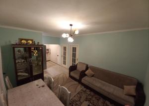 a living room with a couch and a table at happy star stay in Sheki