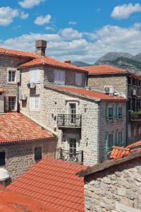 a group of buildings with red tile roofs at Stone Garden Residence in Budva