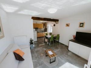a living room with a couch and a table at Apartment Konavec in Kobarid