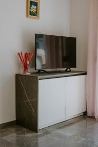 a tv sitting on top of a white cabinet at Apartment Konavec in Kobarid