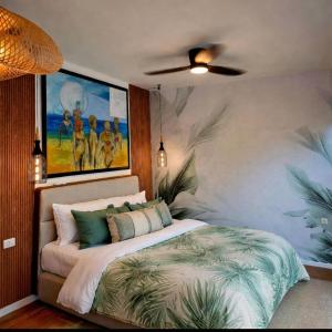 a bedroom with a bed with a painting on the wall at Hoota Cottage Bojana River in Ulcinj