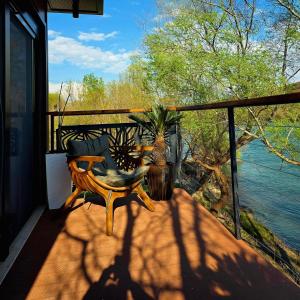 a balcony with a table and a view of the water at Hoota Cottage Bojana River in Ulcinj