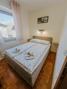 a bedroom with a bed with shoes on it at Apartment Konavec in Kobarid