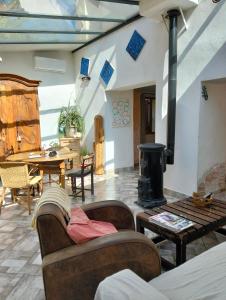 a living room with a wood stove and a table at atypical house garden in Saint-Paulet-de-Caisson