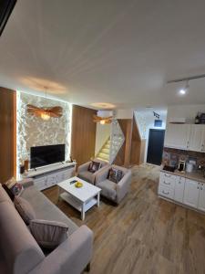 a living room with a couch and a table at Hoota Cottage Bojana River in Ulcinj