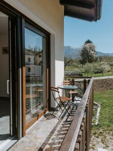 a patio with a table and chairs on a balcony at Apartment Konavec in Kobarid