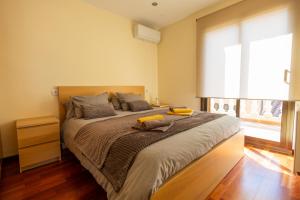 a bedroom with a large bed with a large window at Casa L'Escala 31 in L'Escala +8 photos