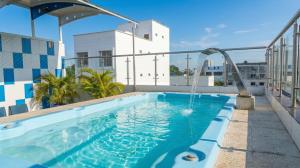 a swimming pool with a water fountain on top of a building at Hotel la Ciudad in Barrancabermeja