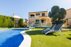 a villa with a swimming pool and a house at Casa L'Escala 31 in L'Escala