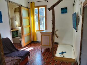 a living room with a couch and a table at atypical house garden in Saint-Paulet-de-Caisson