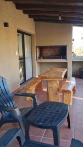 a patio with a table and chairs and a fireplace at Cabañas Altos de San Blas 3 in Pueblito +6 photos