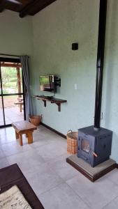 a living room with a stove in a room at Cabañas Altos de San Blas 3 in Pueblito