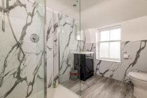 a bathroom with a shower and a toilet at Church View - Elie in Elie +38 photos