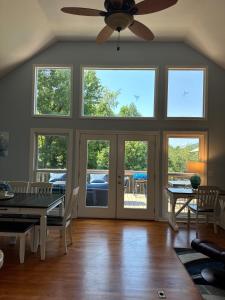 a dining room with a table and a ceiling fan at Serenity Cove in Hiawassee