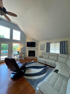 a living room with a white couch and a chair at Serenity Cove in Hiawassee