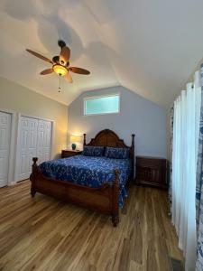 a bedroom with a bed and a ceiling fan at Serenity Cove in Hiawassee