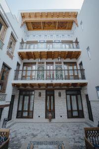 a building with a balcony on top of it at Imranbek Boutique Hotel in Bukhara