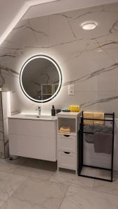 a bathroom with a sink and a mirror at Brickstone Apartments Malbork in Malbork +110 photos