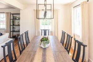 a dining room with a wooden table and chairs at Luxurious Nantucket Getaway Heated Pool in Nantucket