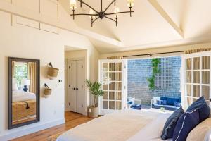 a bedroom with a bed and a large window at Luxurious Nantucket Getaway Heated Pool in Nantucket +38 photos