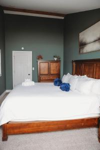 a bedroom with a large white bed with blue pillows at Buckeye Lake Cottage in Buckeye Lake