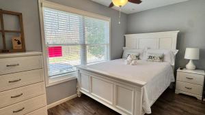 a bedroom with a white bed and a window at The Sands in New Buffalo