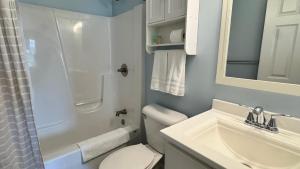 a bathroom with a white toilet and a sink at The Sands in New Buffalo +28 photos