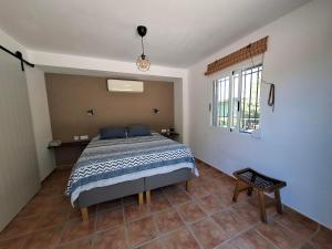 a bedroom with a bed and a window at Finca Mirador in Macastre