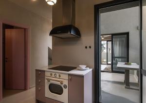 a kitchen with a stove and a stove top oven at Dia Viou Rene in Paradisos +27 photos