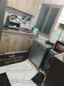 a kitchen with a washing machine and a sink at Amir's home in Meknès