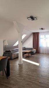 a living room with a couch and a table at Brickstone Apartments Malbork in Malbork