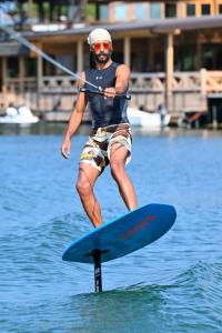 a man on a paddle board in the water at Vienna Montenegro Lleshi in Donji Štoj