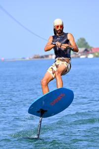 a man on a paddle board in the water at Vienna Montenegro Lleshi in Donji Štoj +12 photos