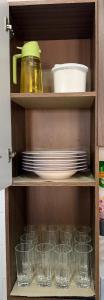 a cupboard filled with empty glasses and plates at Sol e mar in Serra