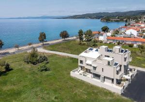 an aerial view of a house next to the water at Dia Viou Rene in Paradisos