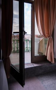 an open glass door with a view of a balcony at Sobe i Apartmani Vila Modex in Paraćin