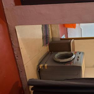 a close up of a washing machine in a room at OceanBliss_Homestay04 in Villupuram +16 photos