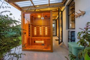 an open door to a house with a glass at Modern Coastal Retreat - Private Hot Tub & Sauna in Hermanus