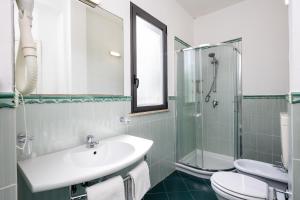a bathroom with a sink and a shower and a toilet at CASA MAJOR Hotel & Appartamenti CERVIA in Cervia +34 photos