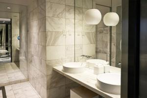 a bathroom with two sinks and a large mirror at Palms Place Hotel and Spa in Las Vegas +36 photos