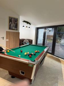 a living room with a pool table in a room at Solaris Zenith View in Buşteni