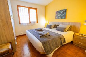 a bedroom with a large bed with towels on it at Casa L'Escala 30 in L'Escala