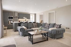 a living room with a couch and a table at Yarwell Mill in Nassington