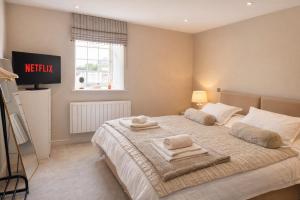 a bedroom with a bed with towels on it at Yarwell Mill in Nassington