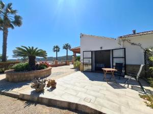 a patio with a table and a building at Finca Mirador in Macastre