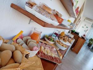 a buffet with many different types of bread and other foods at B&B - TallyHo in Salve +14 photos