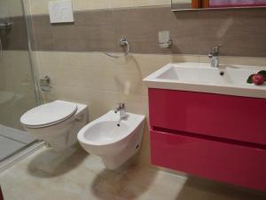 a bathroom with a toilet and a sink at B&B - TallyHo in Salve