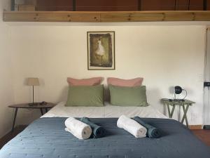 a bedroom with a bed with towels on it at MAS-Calou in Coustellet