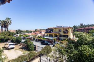 arial view of a residential neighbourhood with cars parked in a parking lot at Casa la Gabbianella in San Teodoro