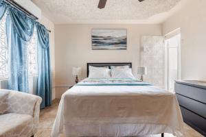 a bedroom with a large bed and a chair at Oceanview Retreat in Bull Bay